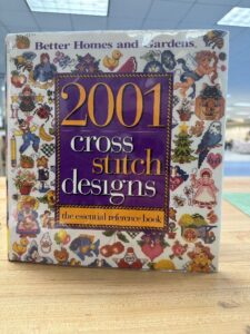 The cover of the book "2001 Cross-stitch Designs."