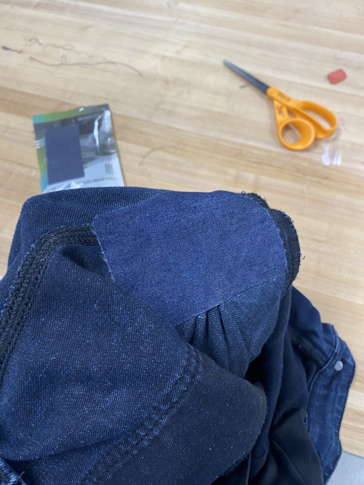 Interior of jeans with patch that has been ironed on.