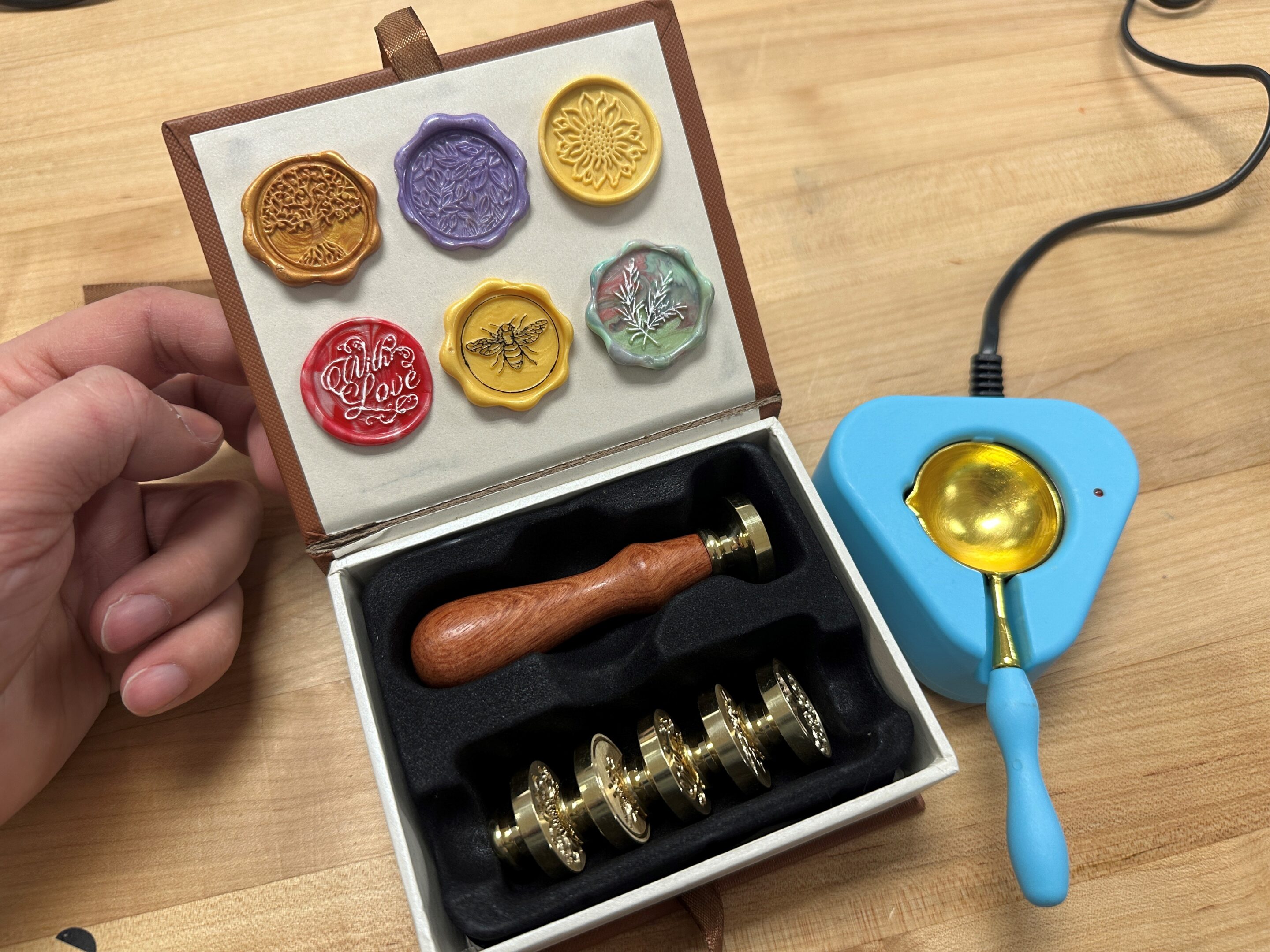 A stamper and wax melt set in Ignite's hand lettering kit.