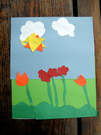 A paper collage depicting five tulips on a green and blue background, with a sun and two clouds.