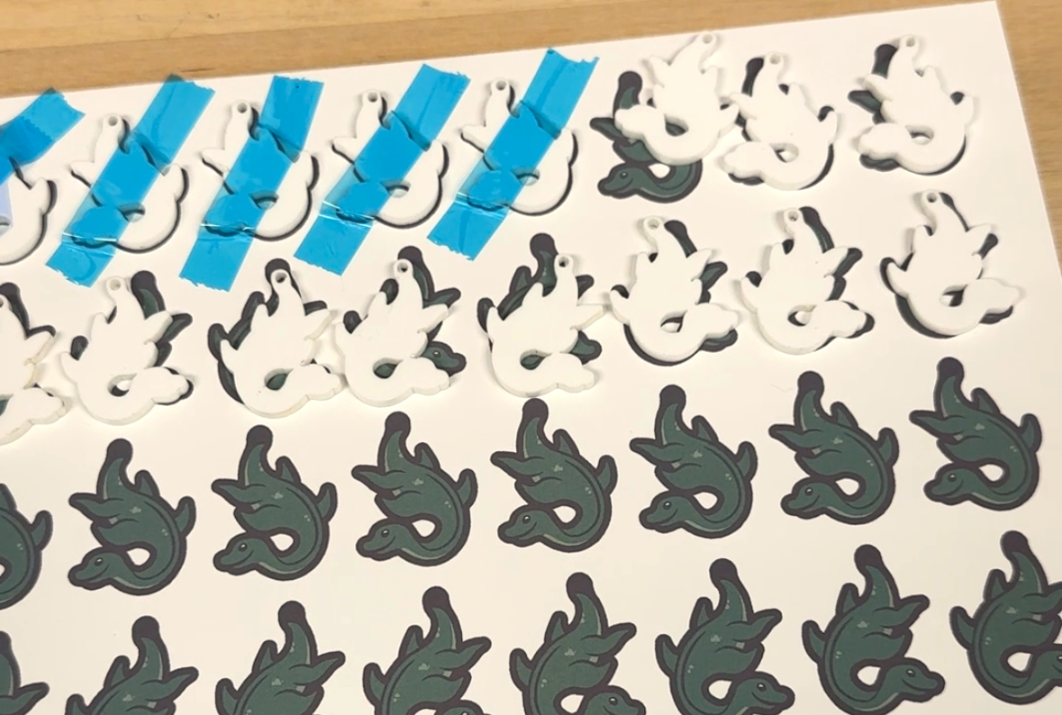 A sheet of acrylic with cut loch ness monsters.