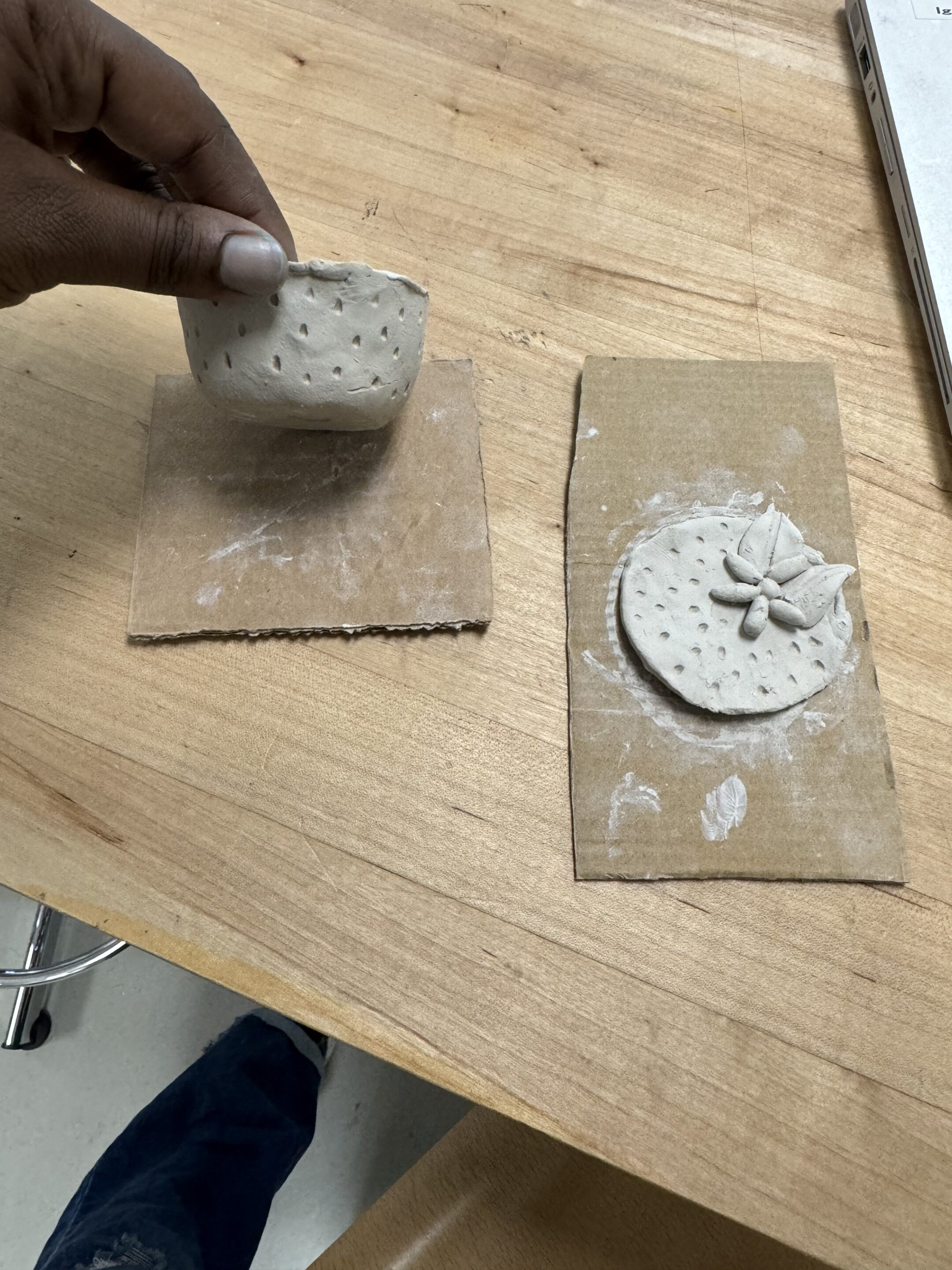 The shaped clay jar and lid with designs.