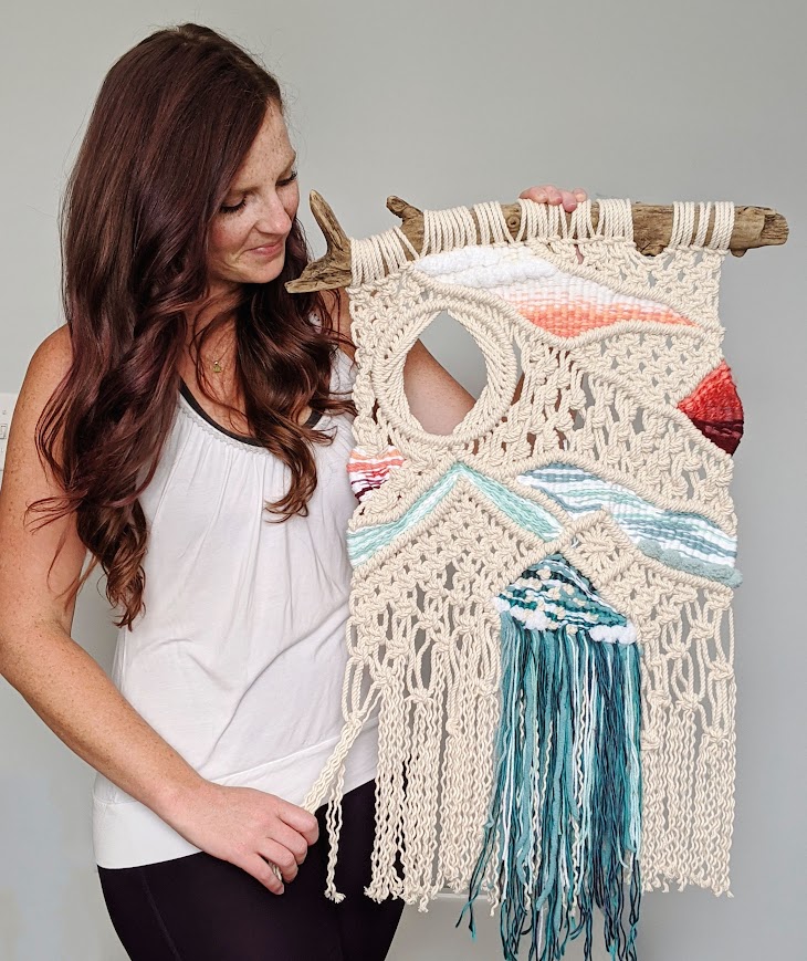 Nicole standing next to an abstract weaving.