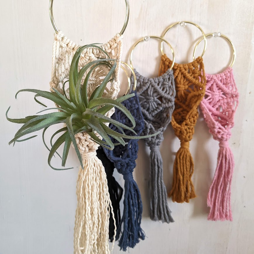 Macrame plant hangers in a variety of colors.