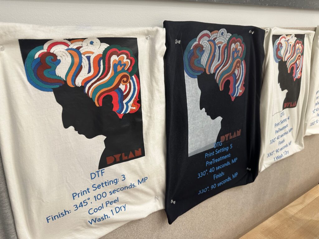 Black and white t-shirts with multicolored printed images. 