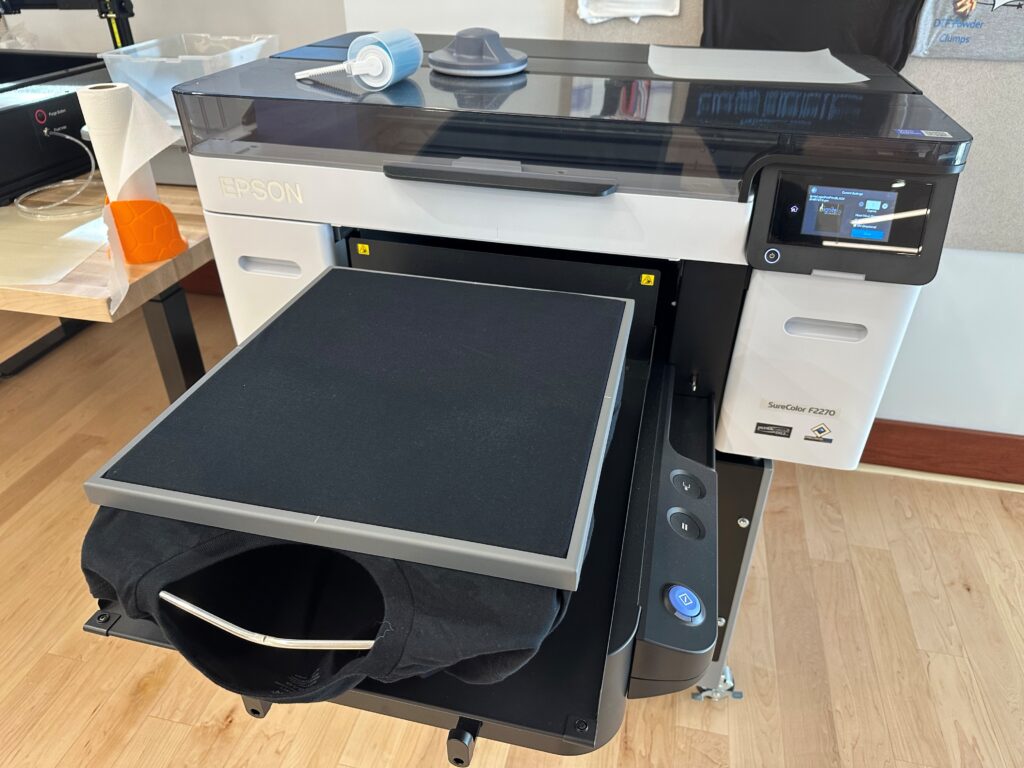 Maker Lab Epson Surecolor printer with black t-shirt loaded on platen.