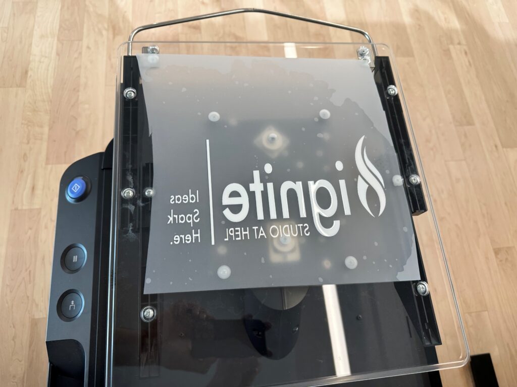 Ignite logo printed in white ink on a film transfer sheet.