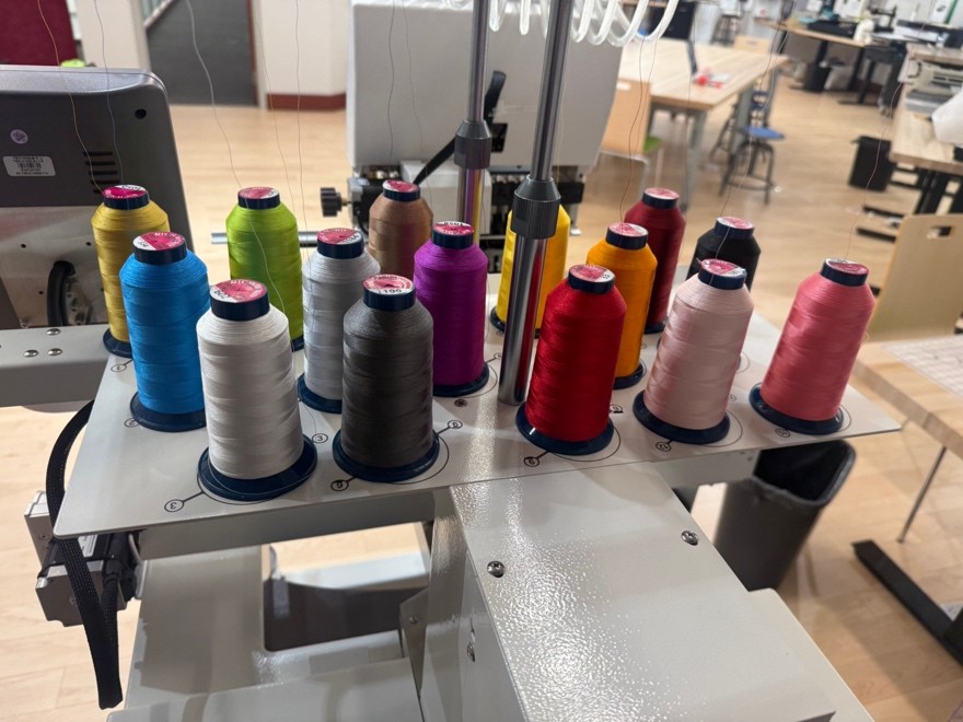 View of 15 embroidery bobbins threaded on the machine. 