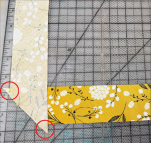 Circles superimposed on the fabric strips to indicate excess fabric
