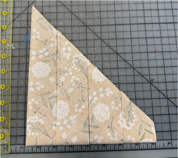 Triangle of fabric trimmed down into 2" segments.