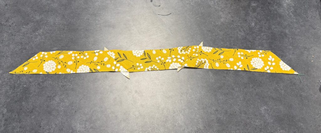 Bias tape strips sewn together and laying flat. 