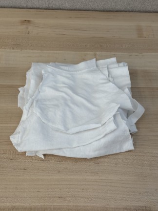 White fabric pieces in a stack.