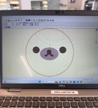 Digital design of Stuffie Face: two brown circles for eyes and an oval shaped mouth.
