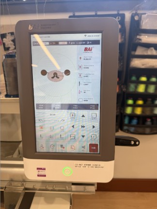 Digital design of face on Embroidery Machine screen.